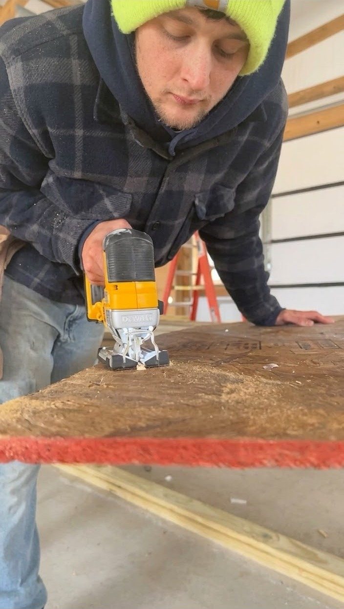 Brent cutting plywood with a jigsaw on a job site