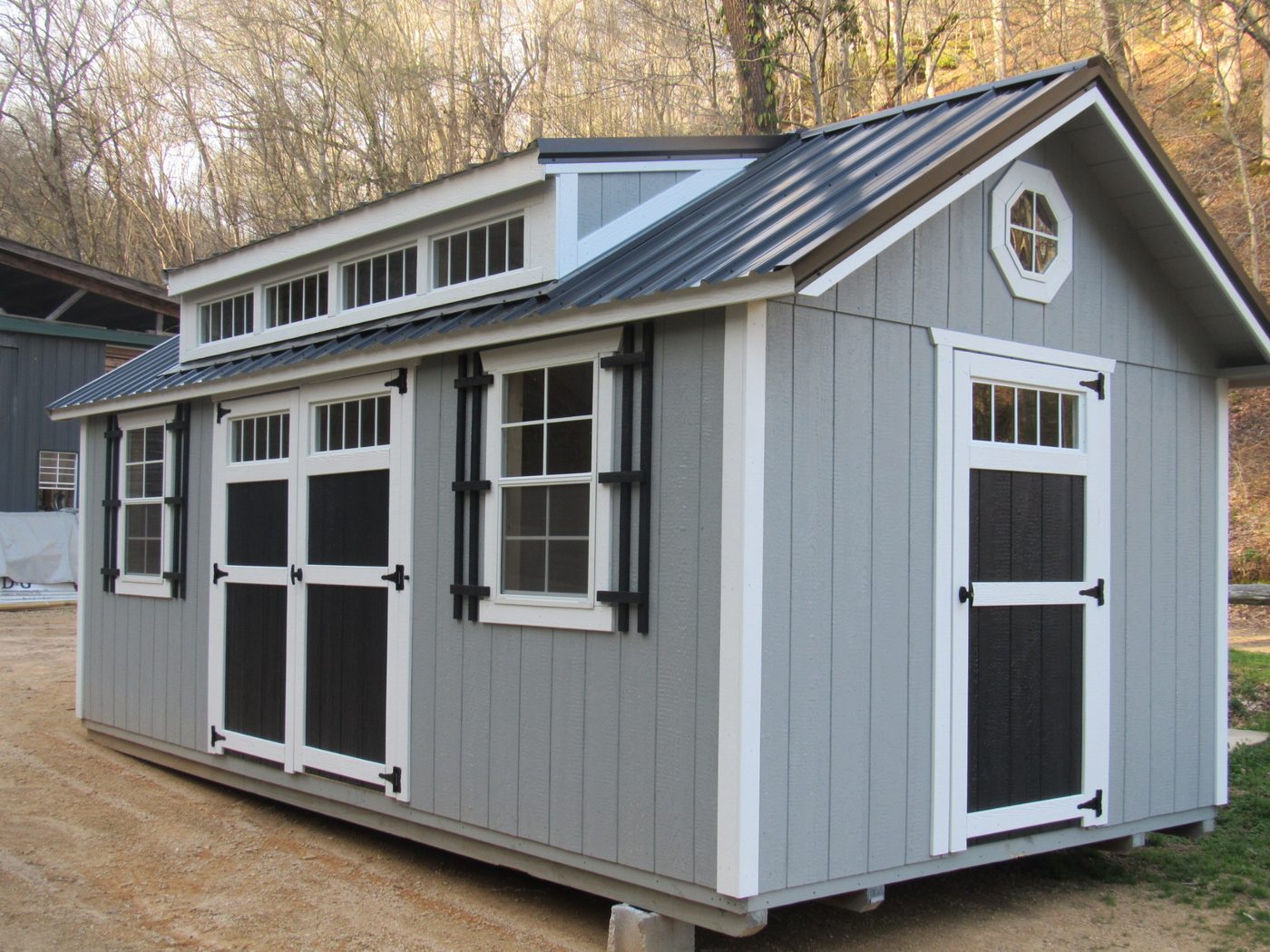 Mission shed with transom dormer and shutters